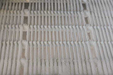 Frozen, icy frost-covered refrigerator tubes in the refrigerator freezer