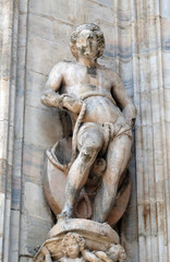 Fototapeta na wymiar Statue of Saint on the facade of the Milan Cathedral, Duomo di Santa Maria Nascente, Milan, Lombardy, Italy