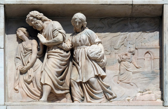 Lot and his daughters flee from Sodom, marble relief on the facade of the Milan Cathedral , Duomo di Santa Maria Nascente, Milan, Lombardy, Italy