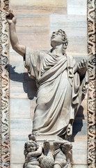 Fototapeta premium Saint John the Evangelist, statue on the Milan Cathedral, Duomo di Santa Maria Nascente, Milan, Lombardy, Italy
