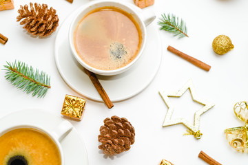 Top view of a cup of coffee, isolate on white with Christmas toys, pine cones, cinnamon, and New Year decor