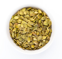 Pumpkin seeds (peeled seeds) in white bowl (Various nuts collection). Isolated on white background.