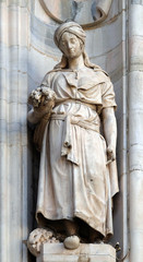 Fototapeta premium Statue of Saint on the facade of the Milan Cathedral, Duomo di Santa Maria Nascente, Milan, Lombardy, Italy