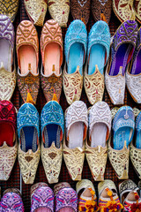 Close up of traditional embroidered Arabian style slippers for sale in a shoe shop in the Bur Dubai Souk market in Dubai in the United Arab Emirates