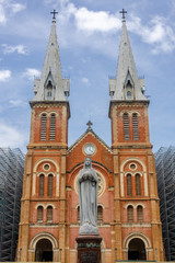 Fototapeta na wymiar The Virgin Mary statue and exterior of Saigon Notre Dame Cathedral Basilica in Ho Chi Minh city, Vietnam. Asia