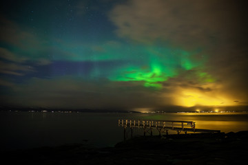 Fototapeta na wymiar Green Aurora Borealis on night sky.