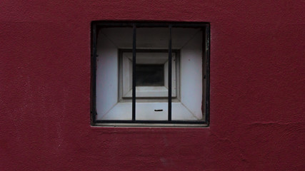 little window on red wall