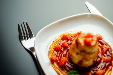 a closeup on a rice dish and a tomato-based sauce, an elegant portion of food