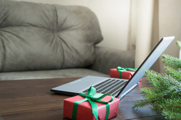Laptop in home interior for booking, search special Christmas offer. Xmas. Planing holidays.