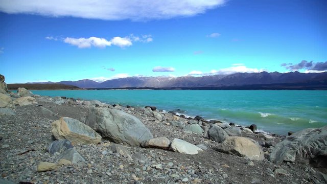 Natural turquoise color water of Lake Tekapo Mackenzie Basin with Southern Alps South Island New Zealand