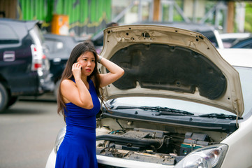 upset Asian Japanese woman in stress stranded on street suffering car engine failure having...