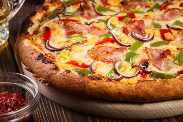 Homemade pizza with bacon, paprika and corn