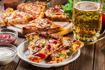 Slices of pizza with bacon, paprika and corn