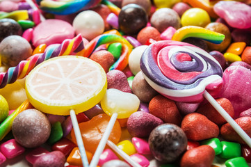 Fototapeta na wymiar background from variety of sweets, lollipops, chewing gum, candies etc