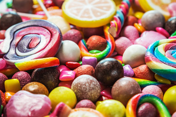 Fototapeta na wymiar background from variety of sweets, lollipops, chewing gum, candies etc
