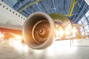 Fotobehang Turbine engine blades during maintenance, the plane in the hangar. © aapsky