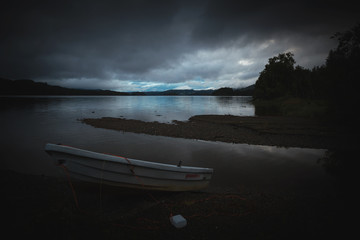 Boat by the lake shore Jonsvatnet lake, Norway.
