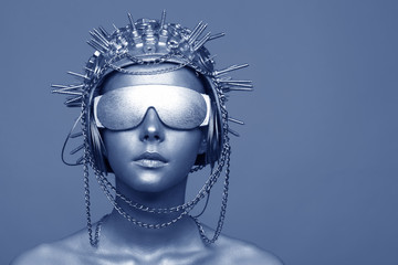 Futuristic woman in metal helmet and glasses