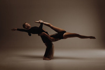 Two young modern ballet dancers in studio