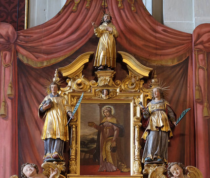 Saint Verena surrounded by the statues of Saints, altar of Saint Maurice in the church of St. Leodegar in Lucerne, Switzerland