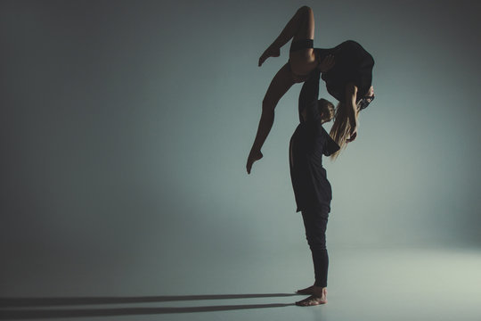 Two young modern ballet dancers in studio