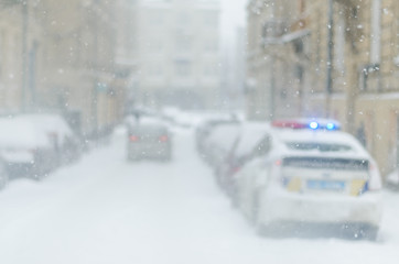 Blurred winter background police car city life bad weather lifestyle blizzard christmas cold falls snow tourists panorama old city