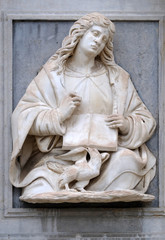Obraz premium Saint John the Evangelist relief on the portal of the Cathedral of Saint Lawrence in Lugano, Switzerland