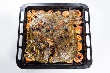 Turbot fish in baking pan oven with potatoes olives and aromatic herbs