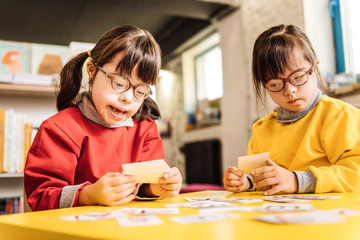 Sisters with Down syndrome playing with cards together