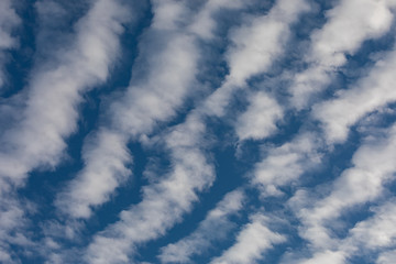 Cirrocumulus clouds against blue sky background pattern