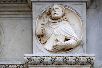 Fototapeta na wymiar Saint, relief on the portal of the Cathedral of Saint Lawrence in Lugano, Switzerland