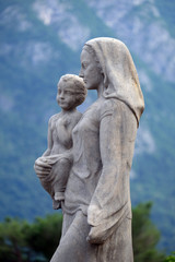 Fototapeta na wymiar Virgin Mary with baby Jesus statue infront of the Cathedral of Saint Lawrence in Lugano, Switzerland