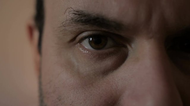 The man is looking at the camera. Close-up. The eyes of man.