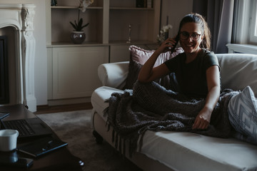 Fototapeta premium Girl smiling while talking on the phone