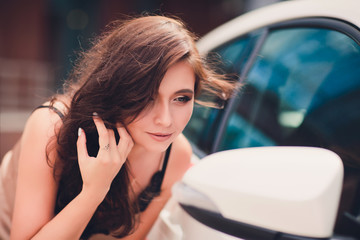 Fototapeta na wymiar Smiling woman is reflected in mirror of car.