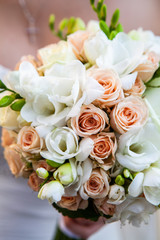 Beautiful wedding bouquet in hands of the bride