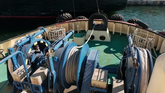 Detail of a powerful towing winch: the reel is equipped with thousands of meters of powerful power cable and end connection. Mooring winches on deck for container vessel, front mooring ropes winches