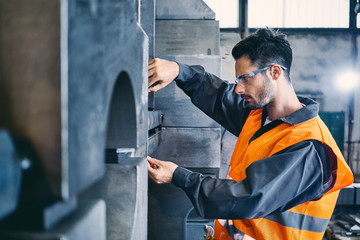 Man wearing protective workwear working in factory