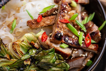 Spicy rice noodles wok with pork and bok choy