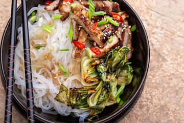 Spicy rice noodles wok with pork and bok choy