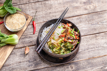 Spicy rice noodles wok with pork and bok choy