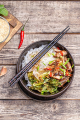 Spicy rice noodles wok with pork and bok choy