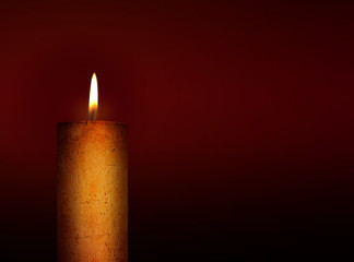 Golden candle on dark background