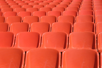 rows of orange seats for spectators of sporting events