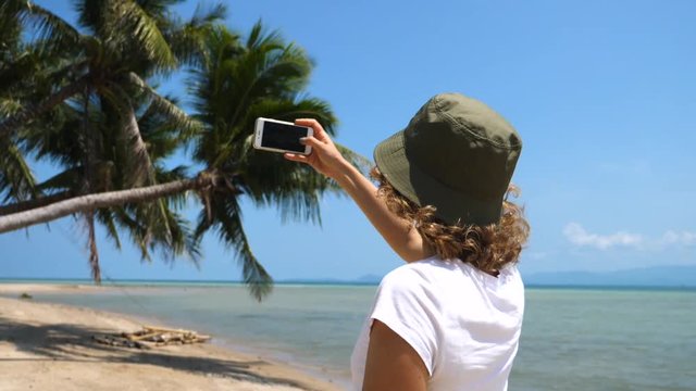 Woman Tourist Taking Photo Of The Beach Using Smartphone. Travel And Technology Concept.
