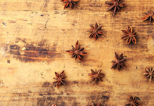 Anise stars on wood background with place for copyspace