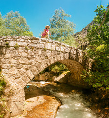 Old arch stone bridge in the mountains