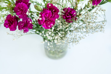 White flowers and fuchsia .flowers on white background.