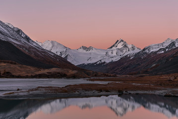 Fototapeta na wymiar sunrise mountains lake reflection snow autumn