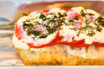 Chicken breast French style with tomato and cheese close